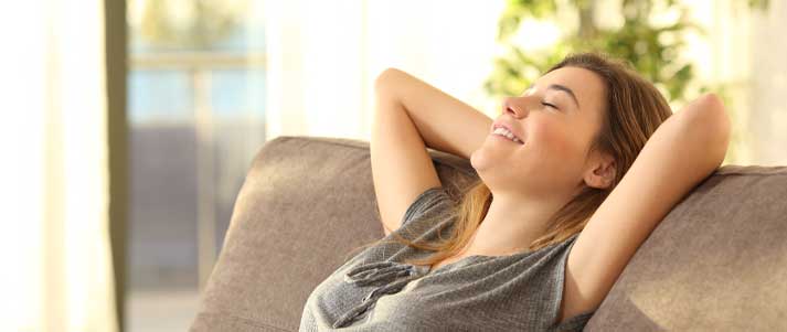 a-young-blonde-woman-relaxing-on-a-sofa