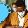 man with mask studying with coronavirus symbol