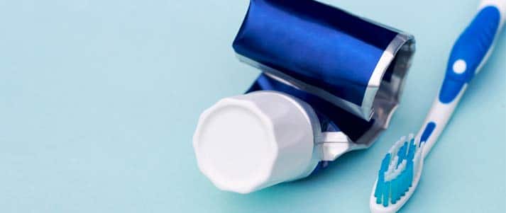 toothbrush and empty toothpaste tube