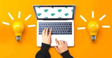 two lightbulbs and a laptop