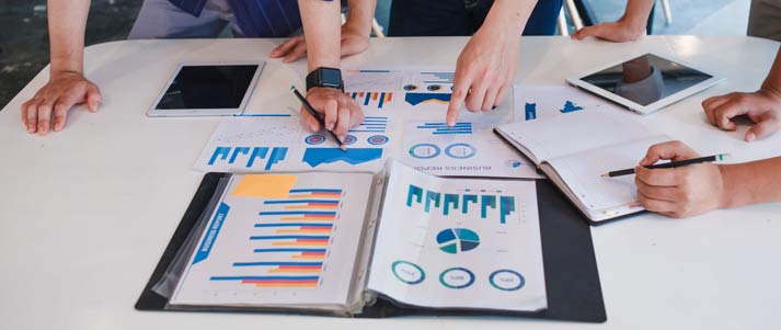 people examining graphs and charts