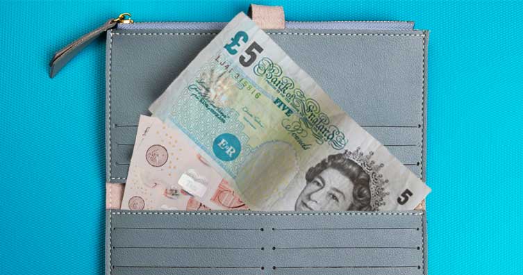 purse with £5 note sticking out