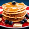 stack of pancakes with fruit toppings